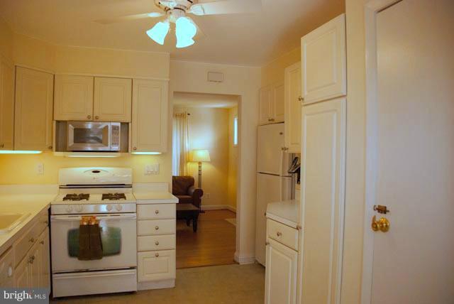 12607 Bluhill Road Silver Spring, MD 20906 - Photo 3 of 26 a kitchen with stainless steel appliances a stove a refrigerator and cabinets