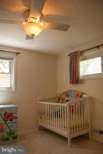 12607 Bluhill Road Silver Spring, MD 20906 - Photo 24 of 26 a bedroom with a bed and a chandelier