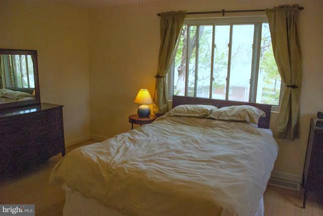 12607 Bluhill Road Silver Spring, MD 20906 - Photo 4 of 26 a bedroom with a bed and a window