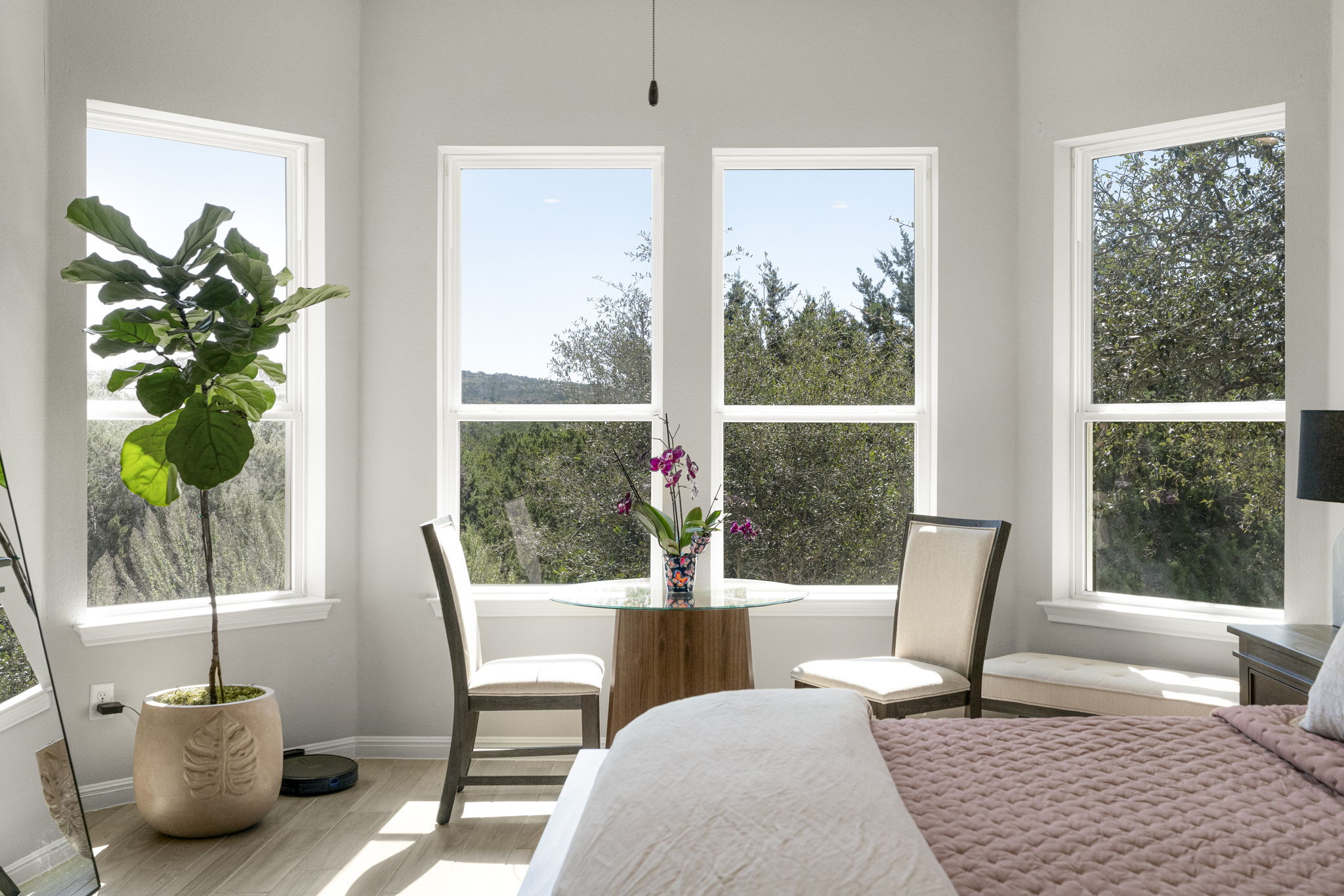 546 Hazy Hills Loop Dripping Springs, TX 78620 - Photo 22 of 40 A cozy sitting area tucked away in the primary bedroom provides an additional living space perfect for reading, conversation, or quiet moments at home, all overlooking the gorgeous backyard views.