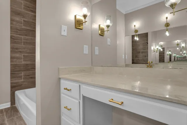 a bathroom with a sink a toilet a shower and a mirror