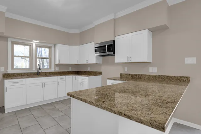 a kitchen with sink cabinets and microwave