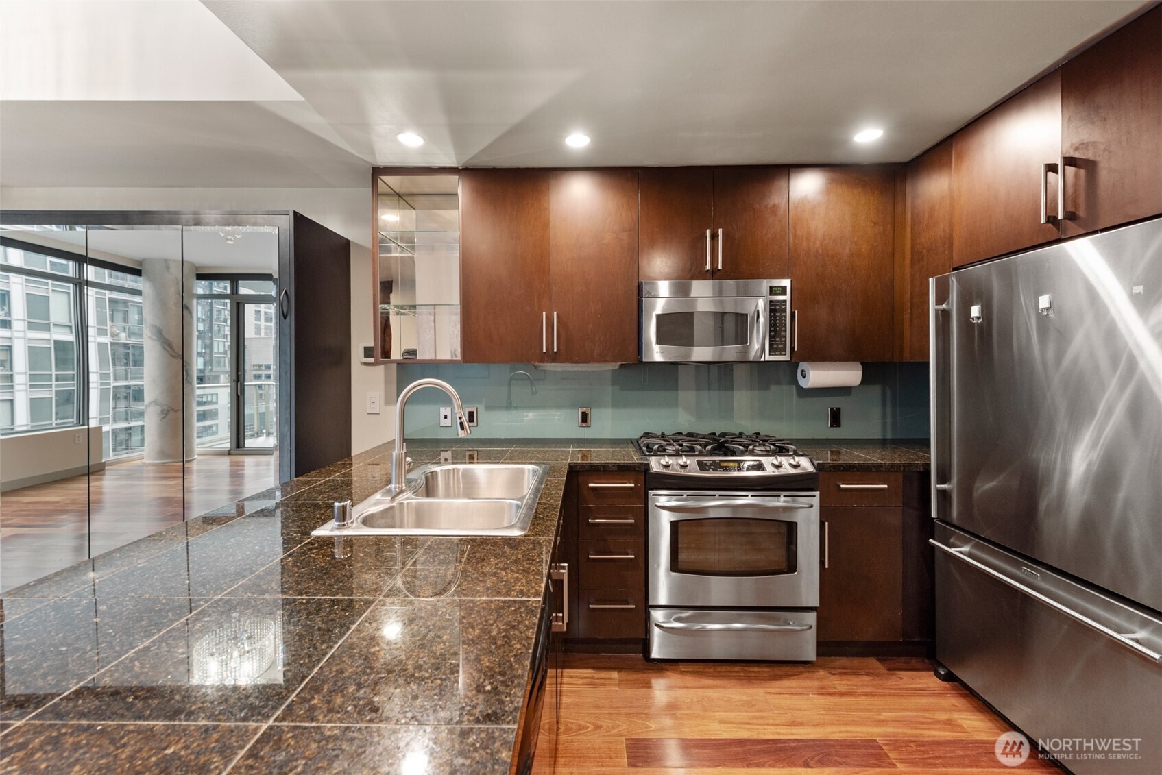 900 Lenora Street, Unit W801 Seattle, WA 98121 - Photo 11 of 36 a large kitchen with stainless steel appliances granite countertop a stove refrigerator and cabinets