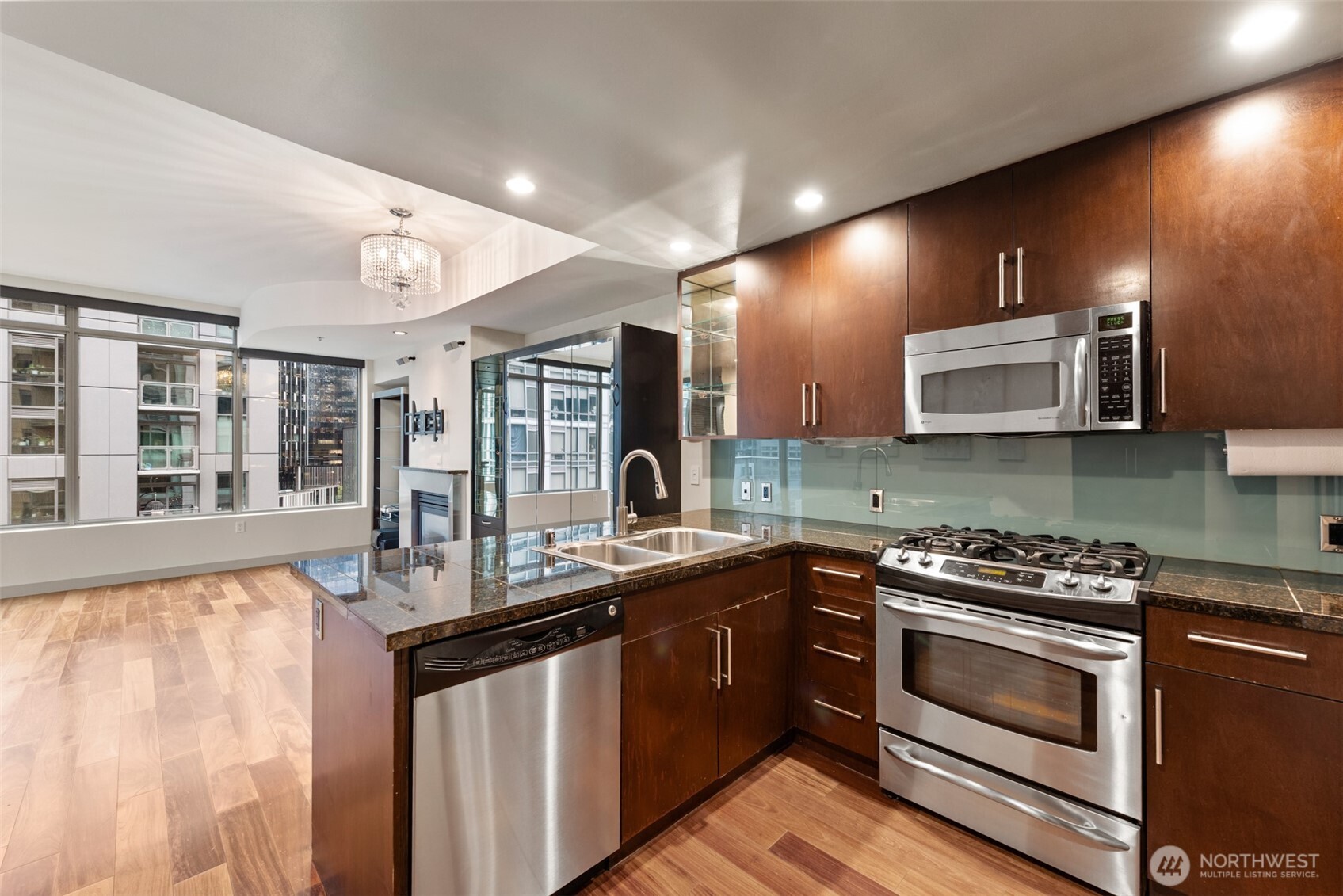 900 Lenora Street, Unit W801 Seattle, WA 98121 - Photo 12 of 36 a kitchen with stainless steel appliances granite countertop a stove a sink and a microwave
