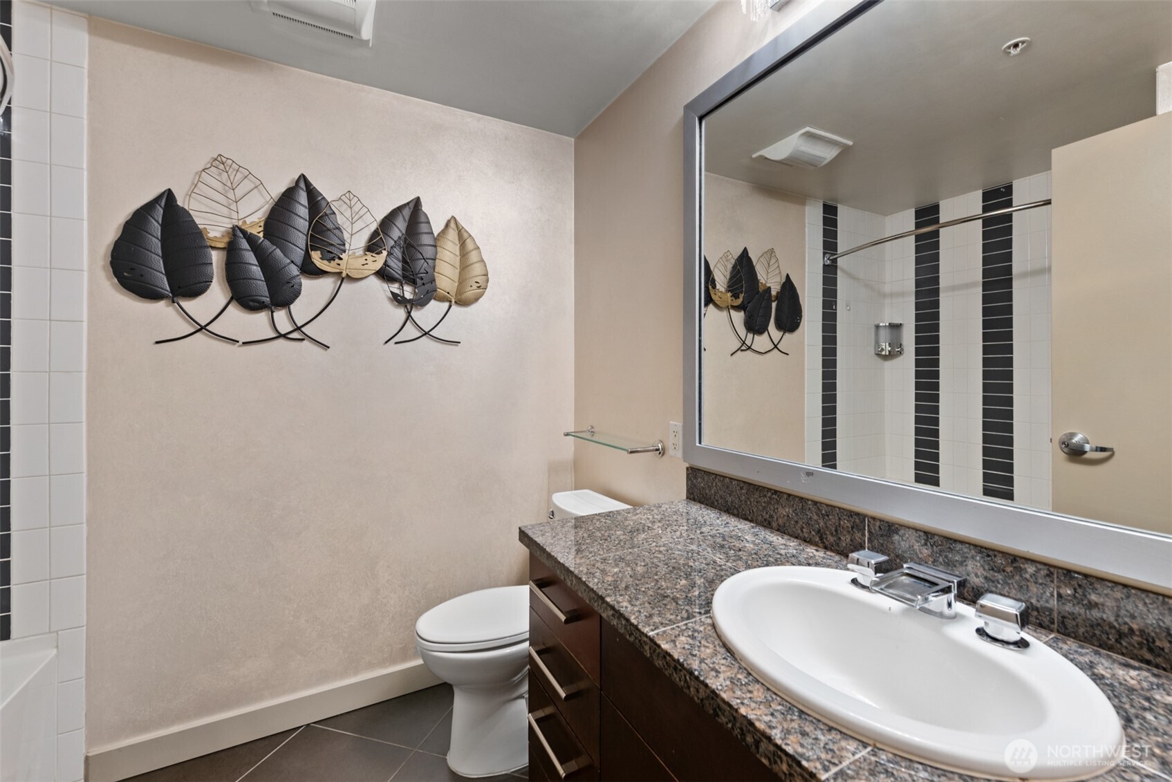 900 Lenora Street, Unit W801 Seattle, WA 98121 - Photo 15 of 36 a bathroom with a granite countertop sink a toilet and a mirror