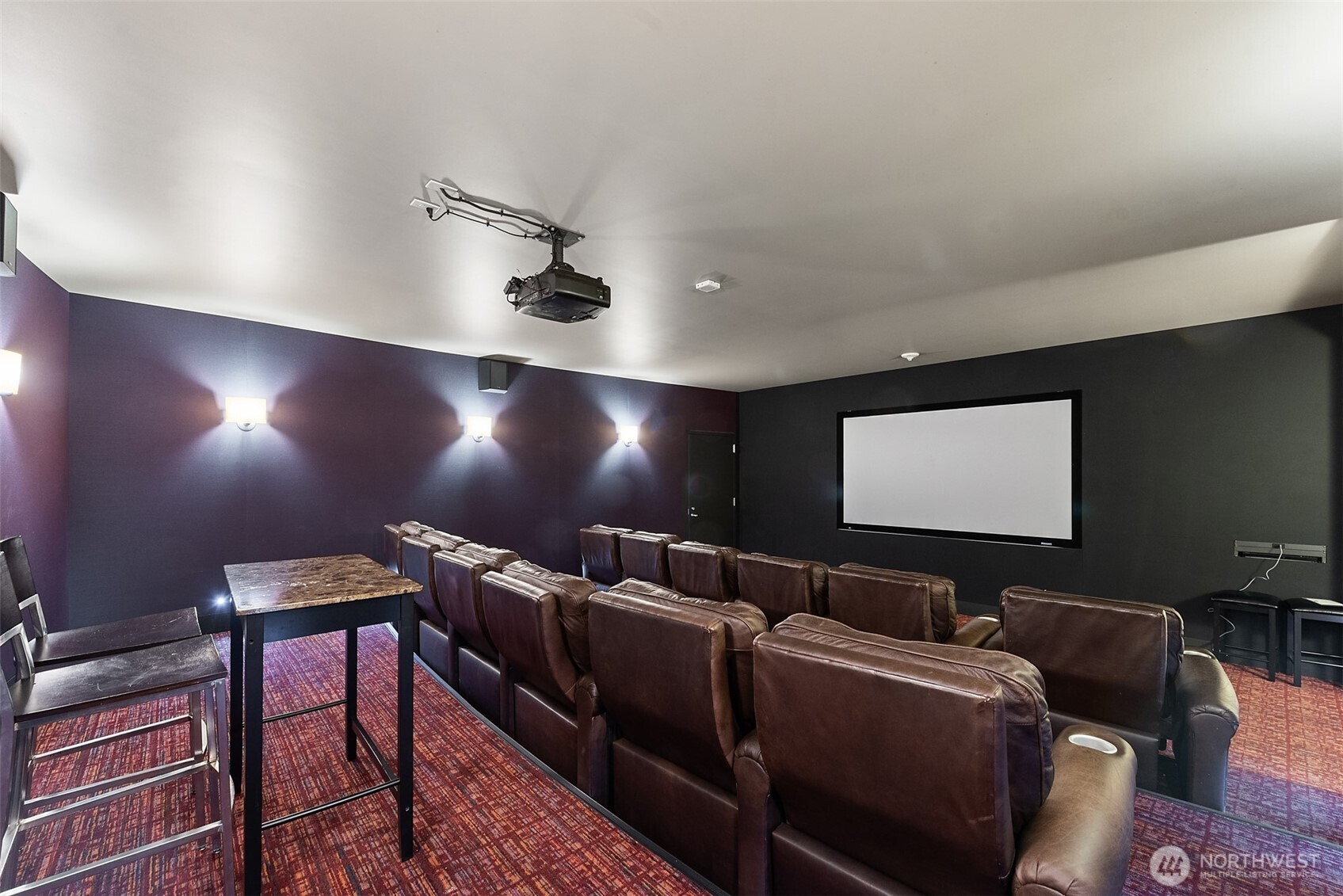 900 Lenora Street, Unit W801 Seattle, WA 98121 - Photo 22 of 36 a media room with lots of chairs and a projector screen