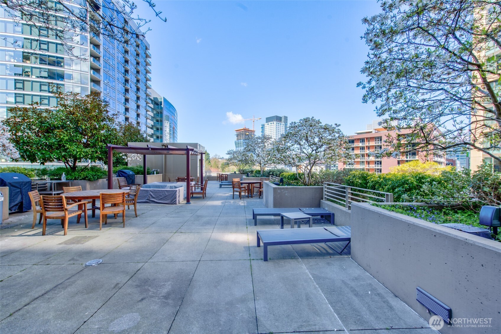 900 Lenora Street, Unit W801 Seattle, WA 98121 - Photo 30 of 36 a view of a patio with a table and chairs
