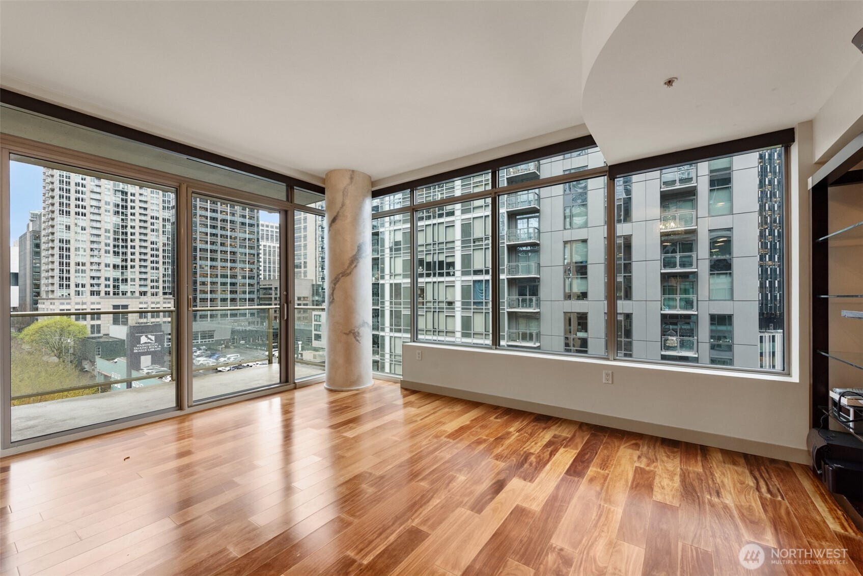 900 Lenora Street, Unit W801 Seattle, WA 98121 - Photo 4 of 36 a view of an empty room with wooden floor and a window