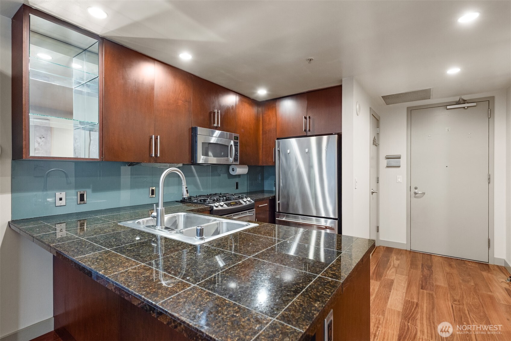 900 Lenora Street, Unit W801 Seattle, WA 98121 - Photo 10 of 36 a kitchen with stainless steel appliances granite countertop a sink refrigerator and microwave