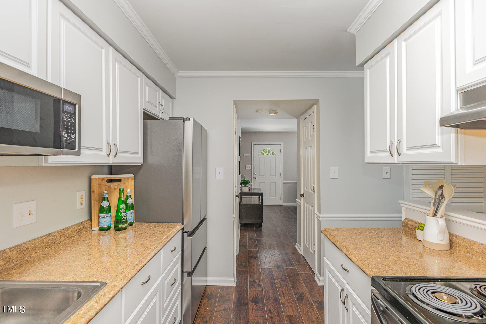 122 Rhum Place Garner, NC 27529 - Photo 7 of 19 a kitchen with stainless steel appliances granite countertop a sink dishwasher stove and refrigerator with wooden floor
