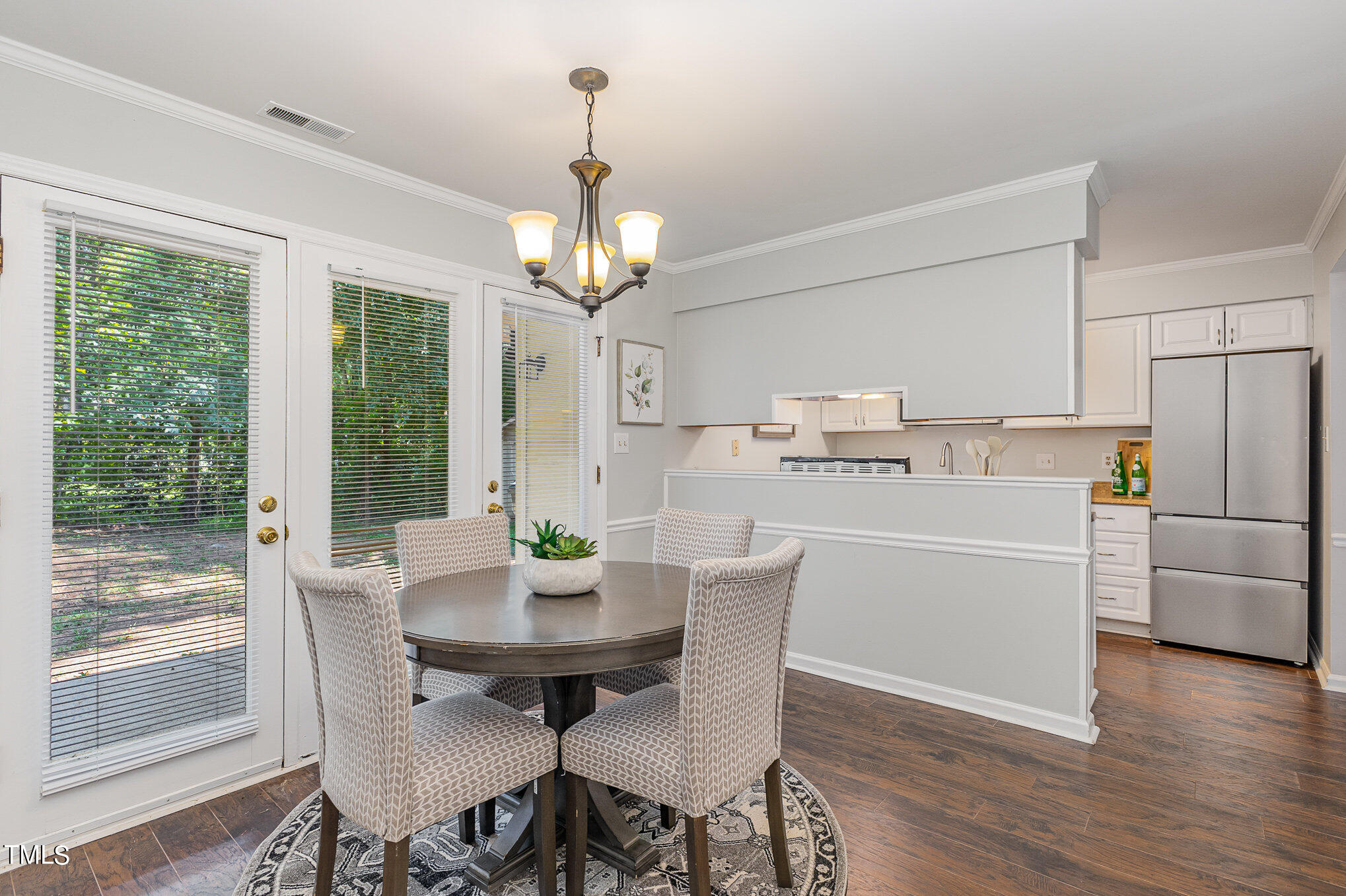 122 Rhum Place Garner, NC 27529 - Photo 9 of 19 a kitchen with stainless steel appliances a dining table chairs and wooden floor