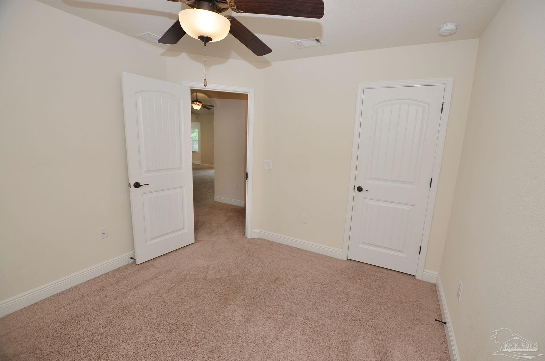 5709 Mill Stream Way Pace, FL 32571 - Photo 39 of 48 an empty room with closet and a chandelier fan