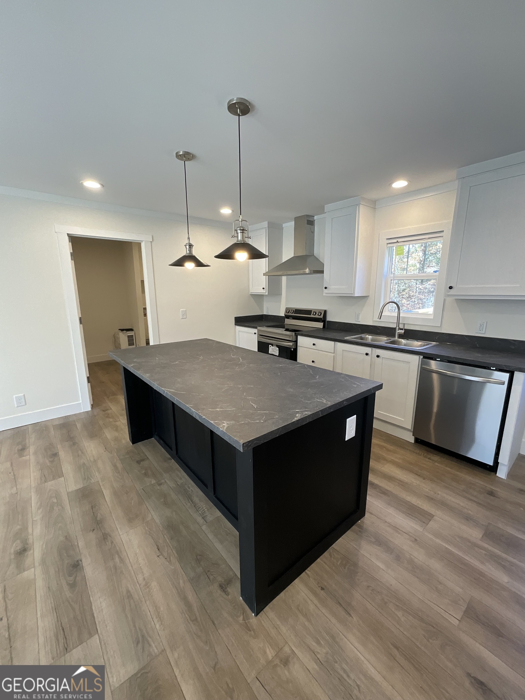 543 Hall Road Franklin, GA 30217 - Photo 18 of 50 a kitchen with stainless steel appliances granite countertop a stove a sink dishwasher a refrigerator and a island with wooden floor