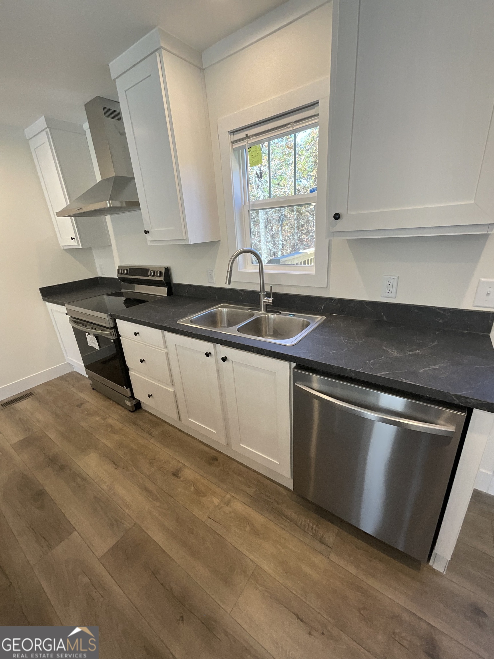 543 Hall Road Franklin, GA 30217 - Photo 19 of 50 a kitchen with stainless steel appliances granite countertop a sink and a stove