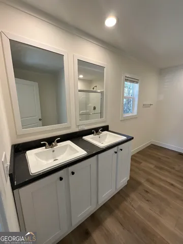 a utility room with a sink and mirror