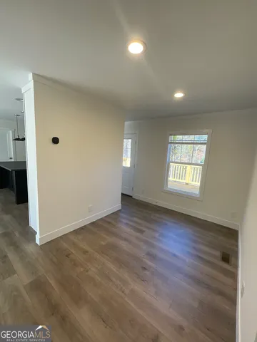 a view of a hallway with wooden floor