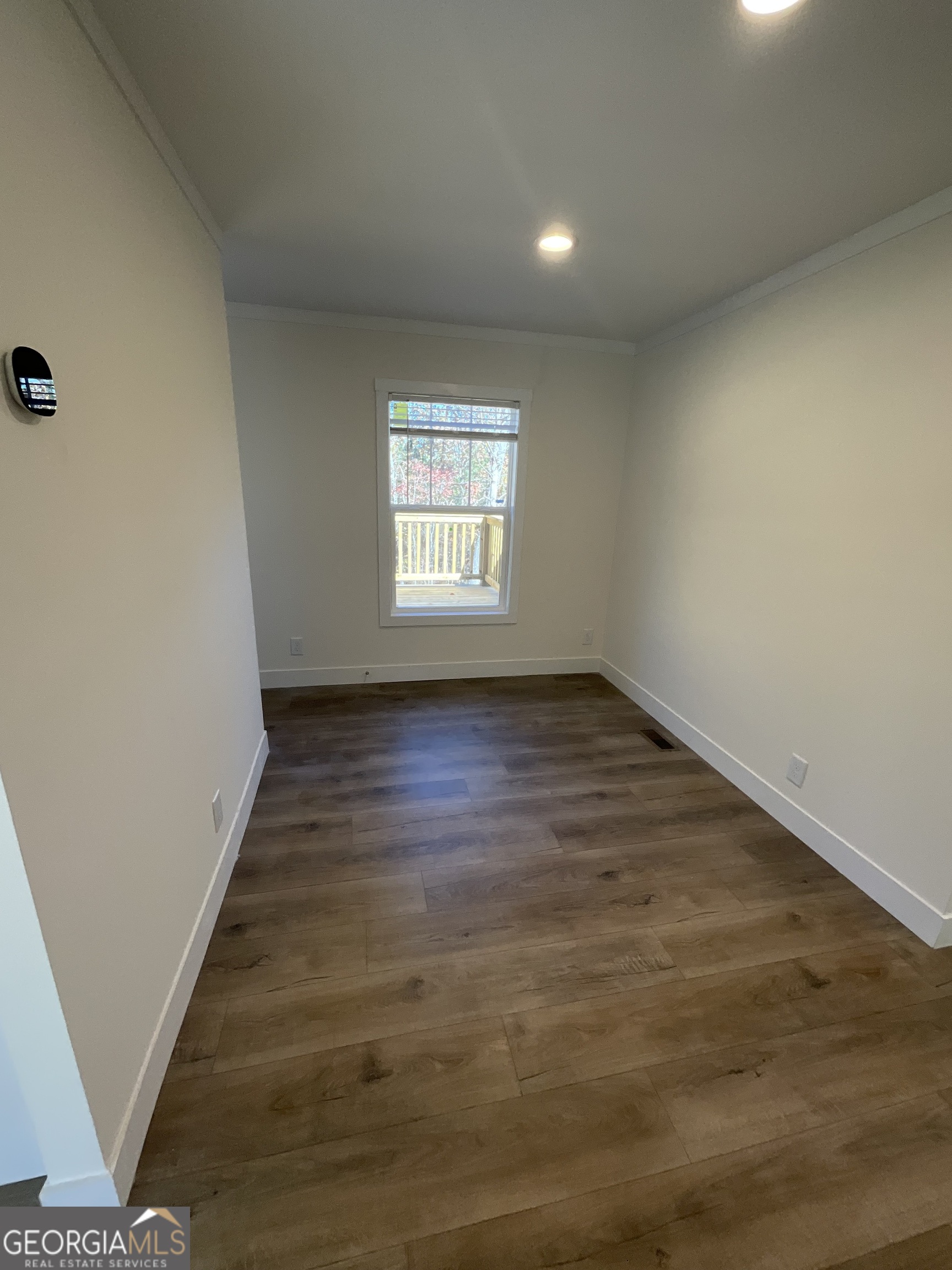 543 Hall Road Franklin, GA 30217 - Photo 37 of 50 an empty room with wooden floor and windows
