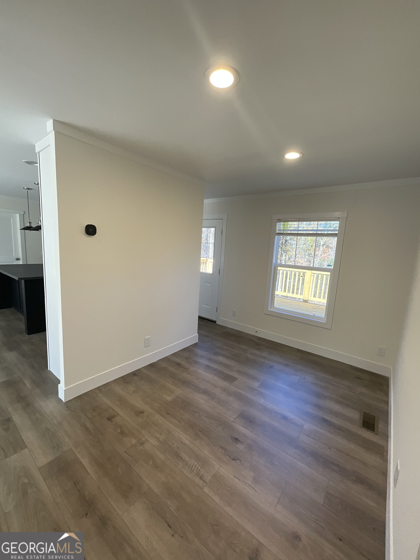 543 Hall Road Franklin, GA 30217 - Photo 38 of 50 an empty room with wooden floor and windows