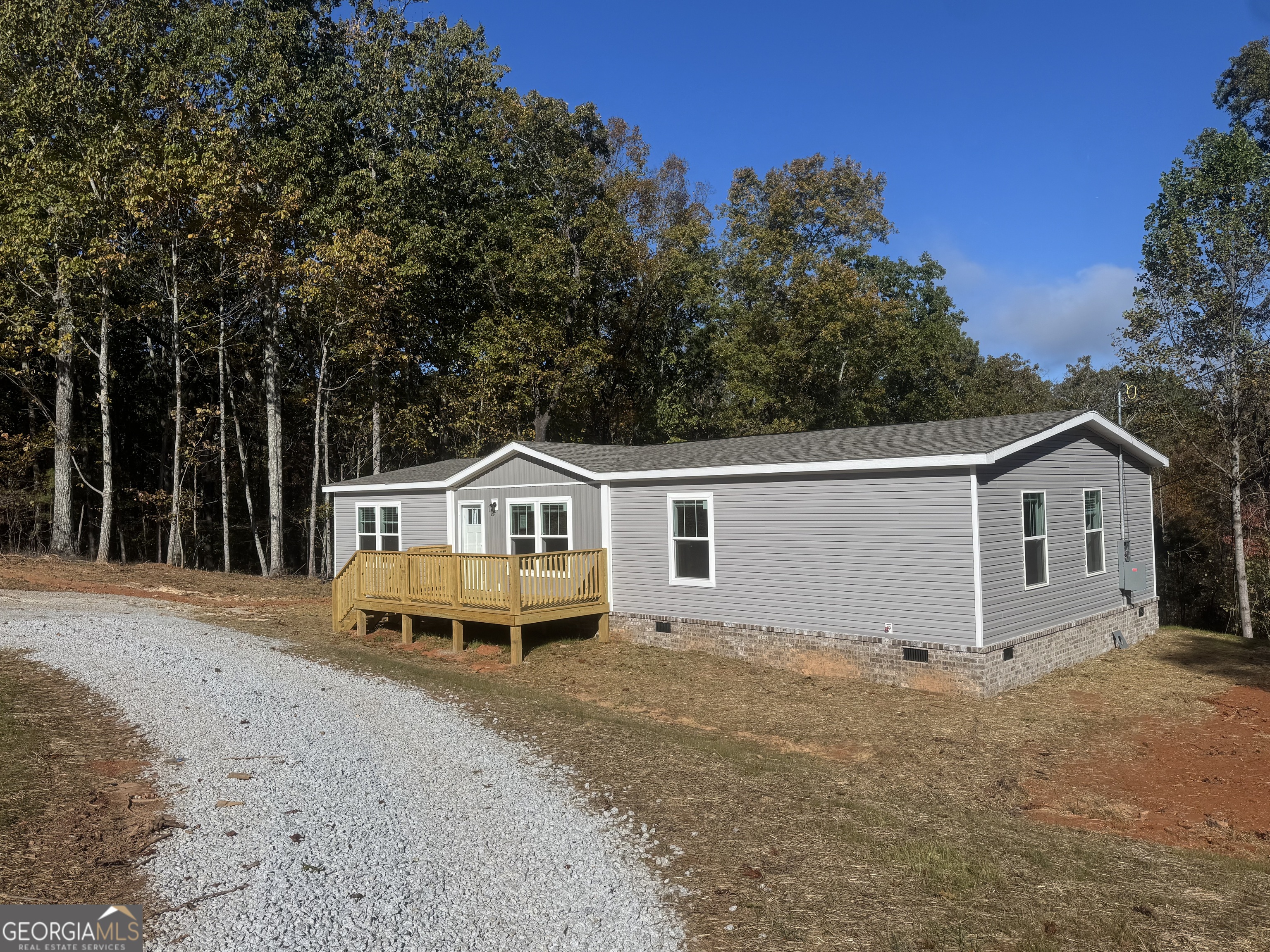 543 Hall Road Franklin, GA 30217 - Photo 4 of 50 a front view of a house with a garden and trees