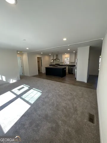 a view of a big room with windows and chandelier