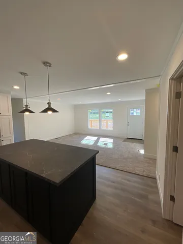 a kitchen with a cabinet a sink and a refrigerator