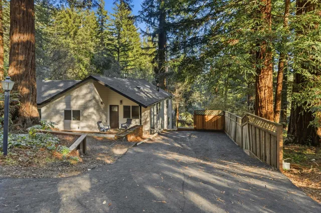 a front view of a house with yard and trees
