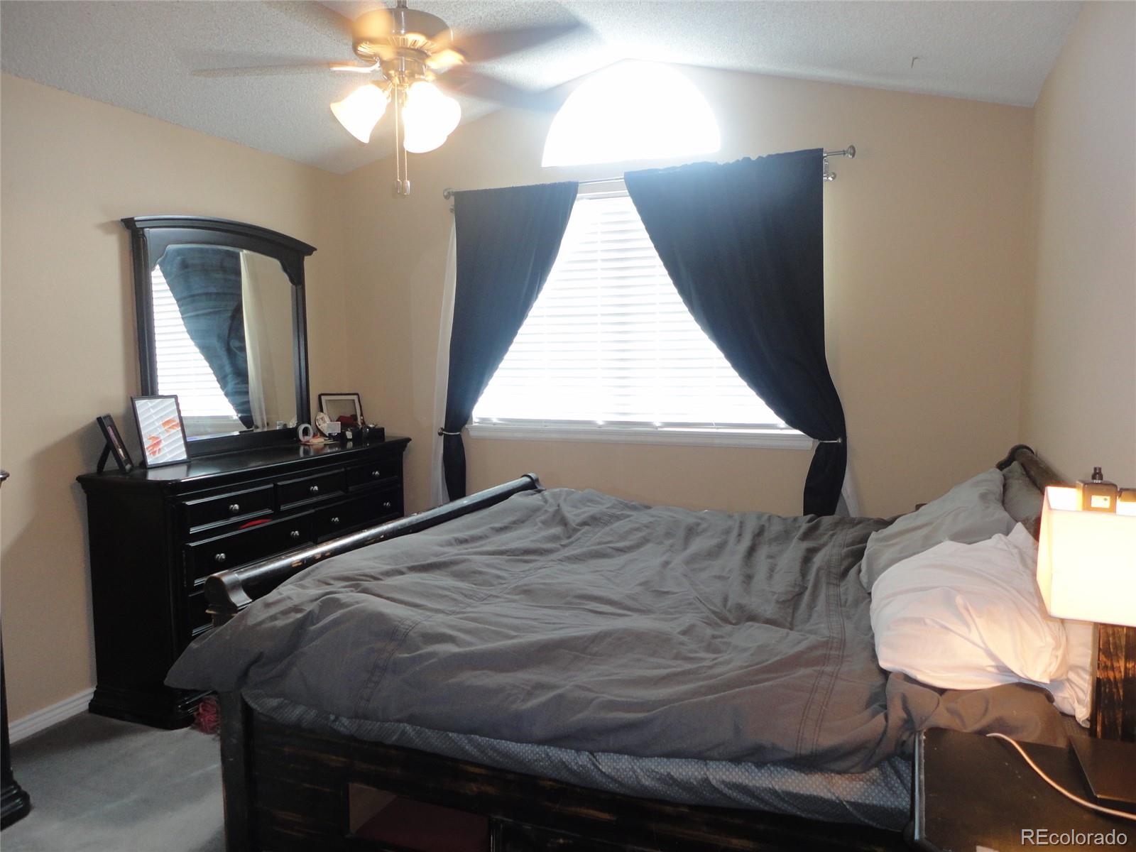 537 James Street Highlands Ranch, CO 80126 - Photo 13 of 28 a bedroom with a bed and a window
