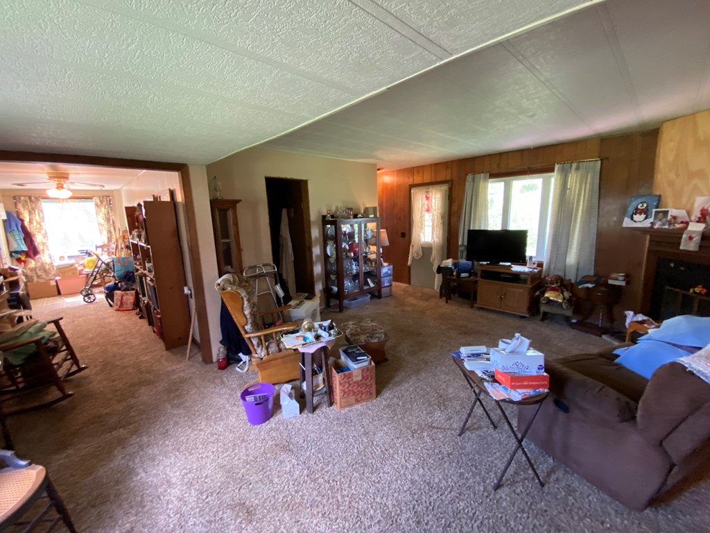 5197 Georgetown Road Franklin, PA 16323 - Photo 12 of 24 a living room with furniture a flat screen tv and a large window