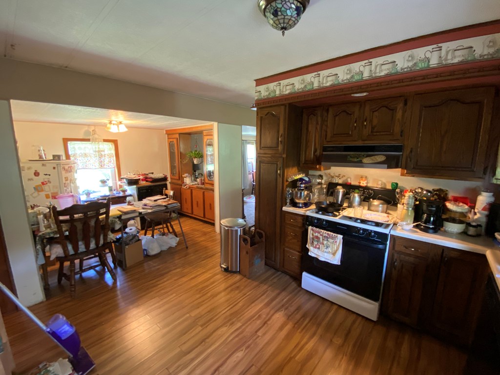 5197 Georgetown Road Franklin, PA 16323 - Photo 18 of 24 a kitchen with stainless steel appliances granite countertop a stove top oven a sink and cabinets