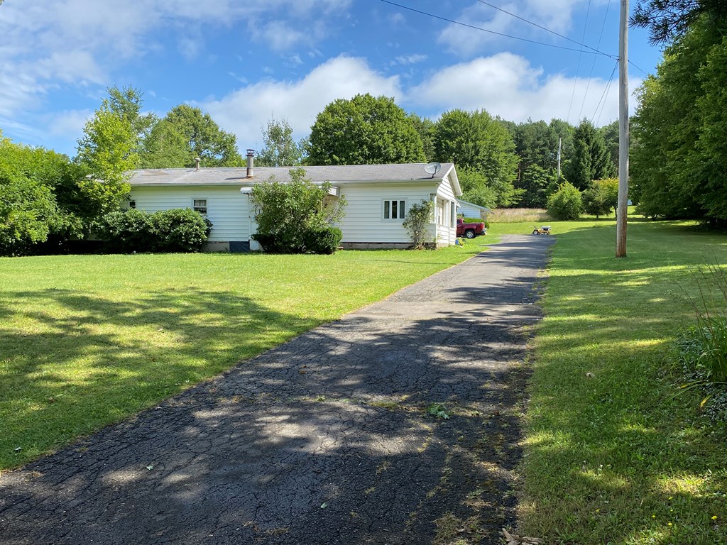 5197 Georgetown Road Franklin, PA 16323 - Photo 8 of 24 a front view of a house with a yard and garage