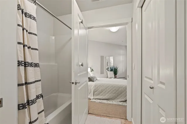 a bedroom with a bed and a shower