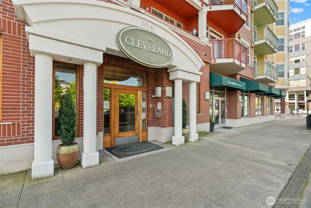 a front view of a residential apartment building with a yard
