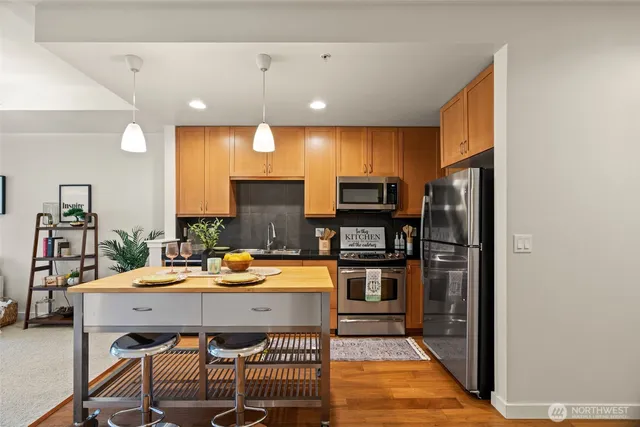 a dining room with a table chairs and a refrigerator