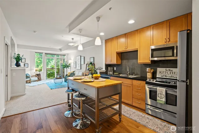 a kitchen with stainless steel appliances a stove a refrigerator and a sink