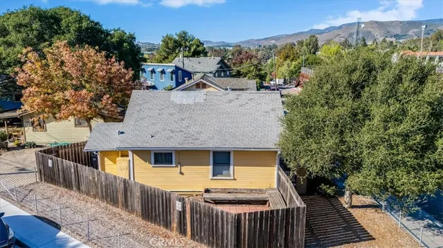a view of a house with wooden fence