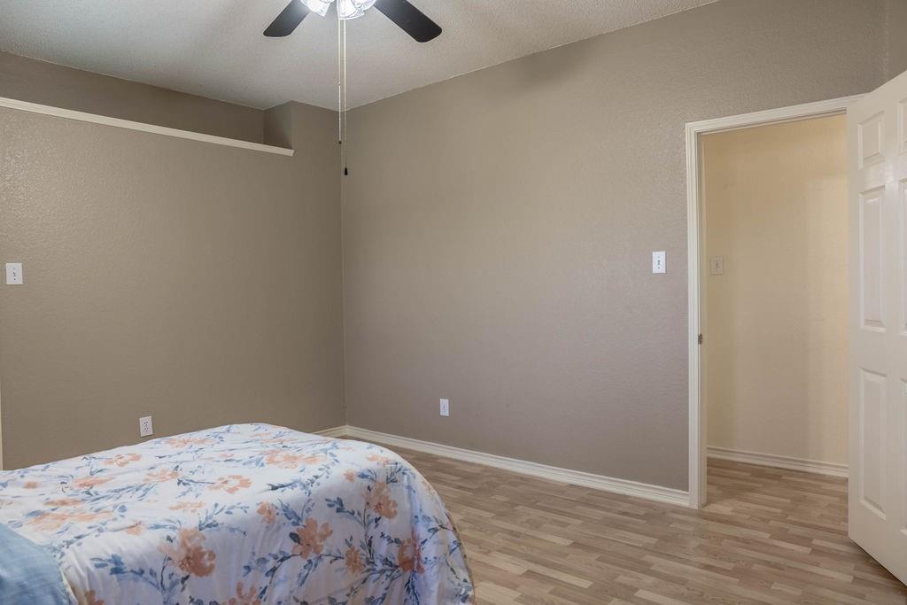 4113 Bluffpoint Road Rowlett, TX 75088 - Photo 30 of 39 a bedroom with a bed and a chandelier fan