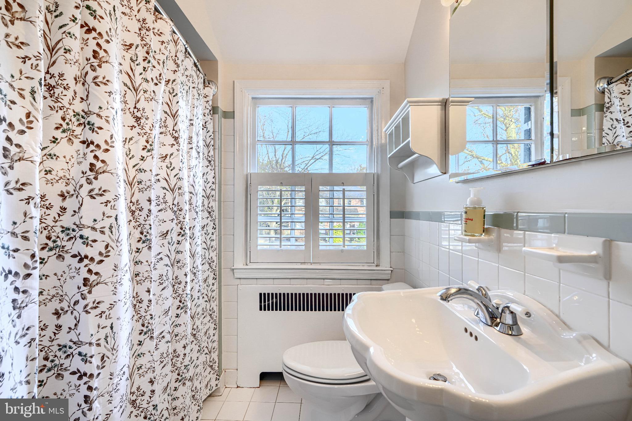 5000 Broadmoor Road Baltimore, MD 21212 - Photo 31 of 51 a bathroom with a sink a toilet and a window