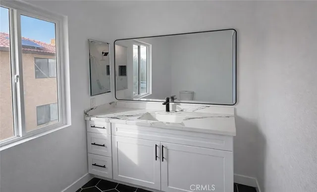a bathroom with a sink and a mirror