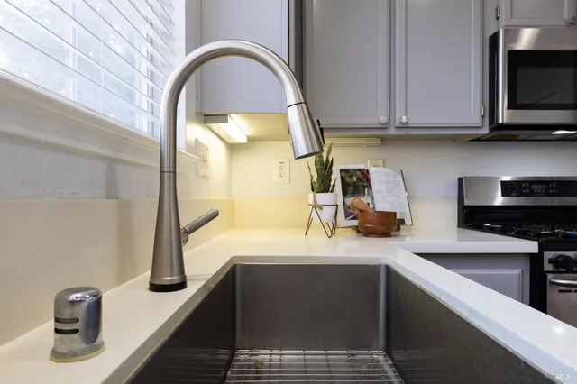 a kitchen with a sink and a stove top oven