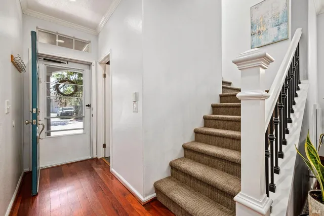 a view of entryway with wooden floor and stairs