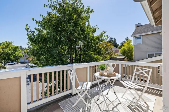 a view of a chairs and table in the balcony