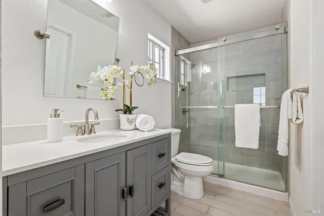 a bathroom with a sink toilet and shower