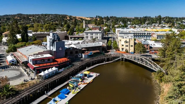 an aerial view of a house with swimming pool and lake view