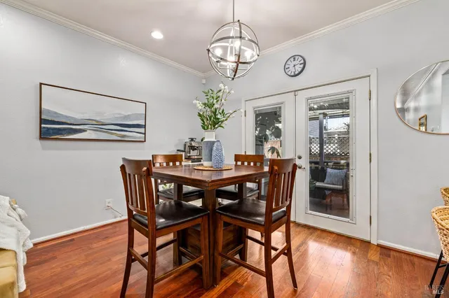 a view of a dining room with furniture wooden floor and a chandelier