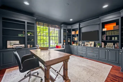 a living room with fireplace furniture and a large window