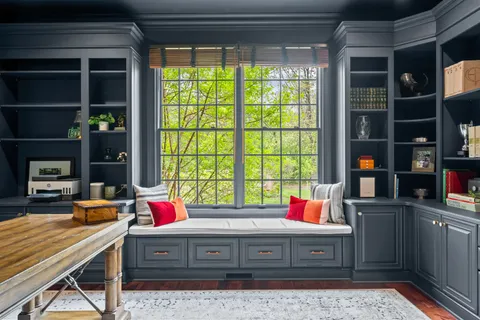 a living room with furniture a chandelier and a potted plant