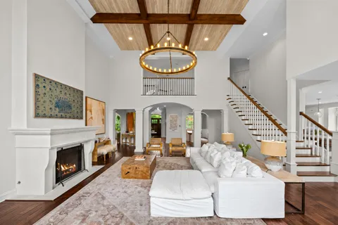 a dining room with furniture wooden floor and a chandelier