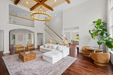 a large kitchen with kitchen island granite countertop a stove a sink a center island and wooden floor