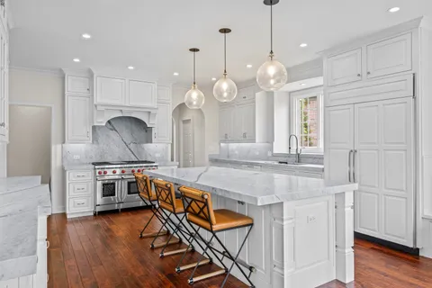 a spacious bathroom with a granite countertop sink mirror and window