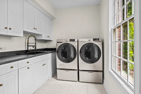 a spacious bathroom with a granite countertop sink and a mirror